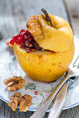 Image showing Baked apple with nuts closeup.
