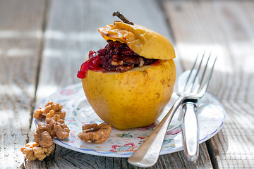 Image showing Baked apple with nuts and cowberry.