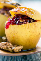 Image showing Baked apple stuffed with berries and nuts.