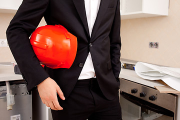 Image showing engineer holding red helmet
