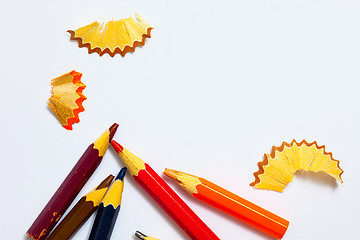 Image showing several aged pencils and shavings on white background