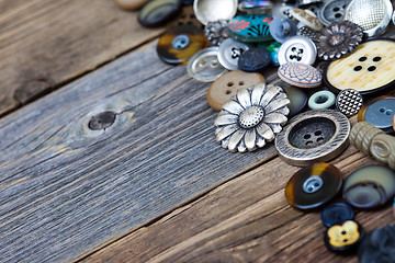 Image showing buttons in large numbers scattered on aged wooden boards