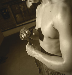 Image showing boxer wraps his hand a red bandage