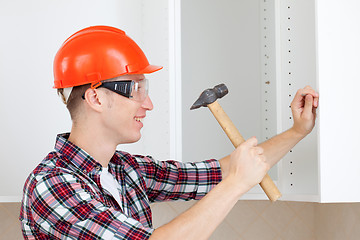 Image showing repairman with hammer