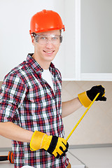 Image showing repairman with a tape measure