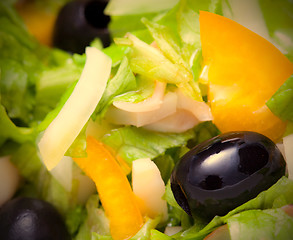 Image showing Assorted salad of green leaf lettuce with squid and black olives