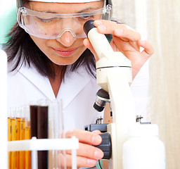 Image showing scientist looking into microscope