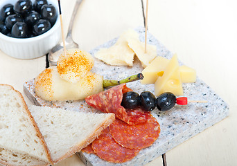 Image showing mix cold cut on a stone with fresh pears