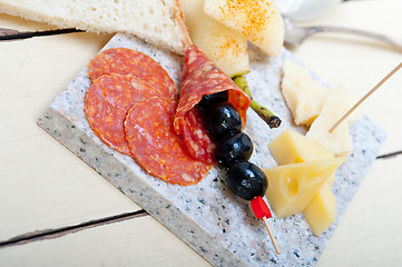 Image showing mix cold cut on a stone with fresh pears