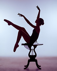 Image showing young ballerina sitting on wooden chair