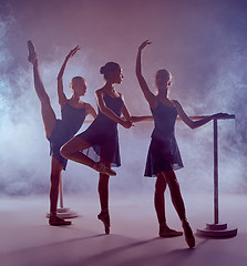 Image showing Ballerinas stretching on the bar