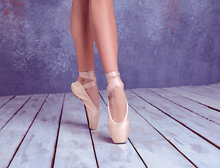 Image showing The feet of a young ballerina in pointe shoes 