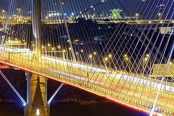 Image showing highway bridge at night with traces of light traffic