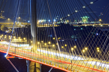 Image showing highway bridge at night with traces of light traffic