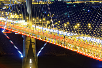 Image showing highway bridge at night with traces of light traffic