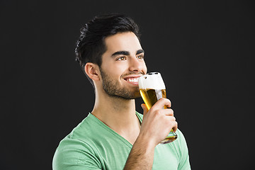 Image showing Young man drinking beer