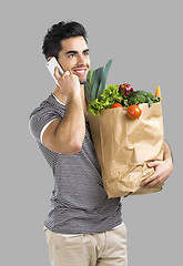 Image showing Man carrying a bag full of vegetables