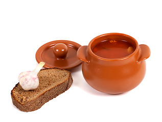 Image showing Borsch in clay pot with bread and garlic