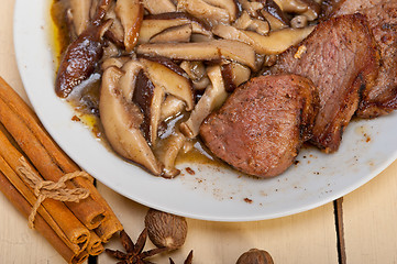 Image showing venison deer game filet and wild mushrooms