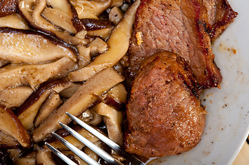 Image showing venison deer game filet and wild mushrooms