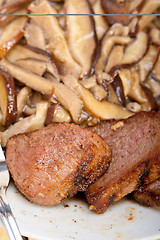 Image showing venison deer game filet and wild mushrooms