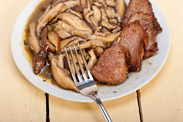 Image showing venison deer game filet and wild mushrooms