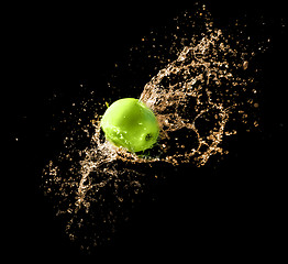 Image showing Green apple with water splash, on black