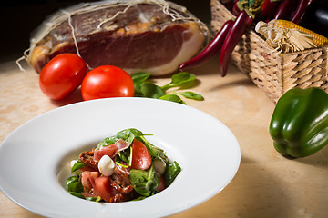 Image showing Salad with strawberry, prosciutto, herbs, cottage cheese and blackberry balsamic vinegar.