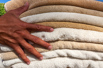 Image showing Stack of white  and broun plush hotel towels 