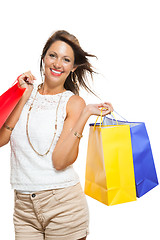 Image showing Happy Woman Raising Colored Shopping Bag