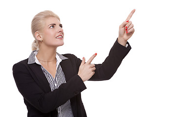 Image showing Businesswoman Pointing Up While Looking at Camera