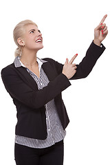 Image showing Businesswoman Pointing Up While Looking at Camera