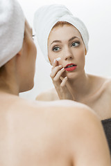 Image showing Woman After Shower Applying Cream on her Face