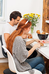 Image showing Couple Preparing Ham Sandwich at the Table