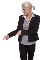 Image showing Businesswoman Pointing Up While Looking at Camera