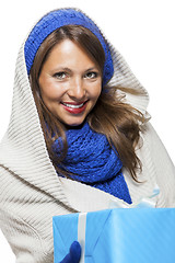 Image showing Young woman holding a blue gift