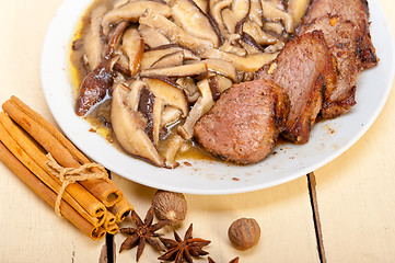 Image showing venison deer game filet and wild mushrooms