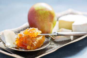 Image showing Honey comb, ripe pear and brie.