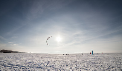 Image showing Kiteboarder with blue kite on the snow