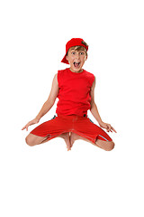 Image showing Excited boy jumping off the ground.