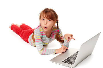 Image showing Surprised girl pointing at laptop screen