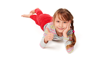 Image showing Front view of smiling child girl lying on stomach