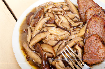 Image showing venison deer game filet and wild mushrooms