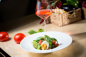 Image showing plate of spring mix salad with strawberry, eggs and tuna