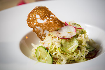 Image showing Salad from cabbage, herbs, cucumber and radish in bowl.