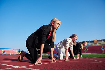 Image showing business people running on racing track