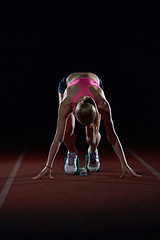 Image showing woman  sprinter leaving starting blocks