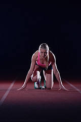 Image showing woman  sprinter leaving starting blocks