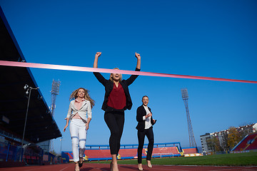 Image showing business people running on racing track