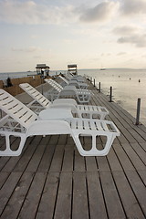 Image showing Chaise longues on pier